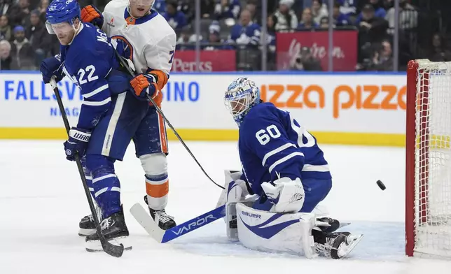 Toronto Maple Leafs goaltender Joseph Woll (60) reacts after New York Islanders center Bo Horvat (not shown) scored during third-period NHL hockey game action in Toronto, Saturday, Dec. 21, 2024. (Frank Gunn/The Canadian Press via AP)