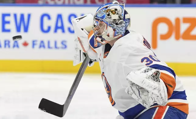 New York Islanders goaltender Ilya Sorokin (30) watches the puck during the second period of an NHL hockey game against the Toronto Maple Leafs in Toronto, Saturday, Dec. 21, 2024. (Frank Gunn/The Canadian Press via AP)