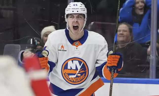 New York Islanders center Jean-Gabriel Pageau (44) reacts after scoring his team's third goal on Toronto Maple Leafs goaltender Joseph Woll during the first period of an NHL hockey game in Toronto, Saturday, Dec. 21, 2024. (Frank Gunn/The Canadian Press via AP)