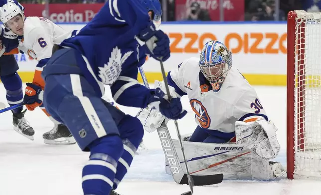 New York Islanders goaltender Ilya Sorokin (30) watches a Toronto Maple Leafs player control the puck at the side of his net during the second period of an NHL hockey game in Toronto, Saturday, Dec. 21, 2024. (Frank Gunn/The Canadian Press via AP)