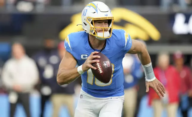 Los Angeles Chargers quarterback Justin Herbert (10) rolls out during the first half an NFL football game against the Tampa Bay Buccaneers, Sunday, Dec. 15, 2024, in Inglewood, Calif. (AP Photo/Eric Thayer)