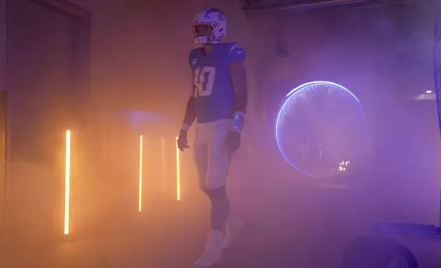 Los Angeles Chargers quarterback Justin Herbert (10) prepares to enter the field before an NFL football game against the Tampa Bay Buccaneers, Sunday, Dec. 15, 2024, in Inglewood, Calif. (AP Photo/Eric Thayer)