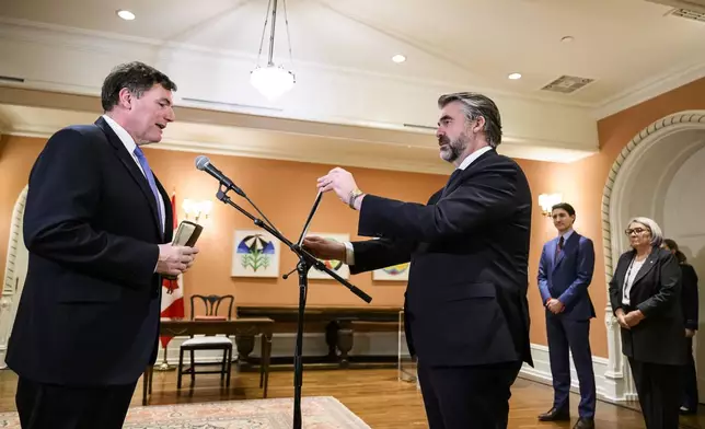 Dominic LeBlanc is sworn in as Minister of Finance by Clerk of the Privy Council John Hannaford, centre, as Canada's Prime Minister Justin Trudeau and Gov. Gen. Mary Simon look on, during a ceremony at Rideau Hall in Ottawa, Ontario, Monday, Dec. 16, 2024. (Justin Tang/The Canadian Press via AP)