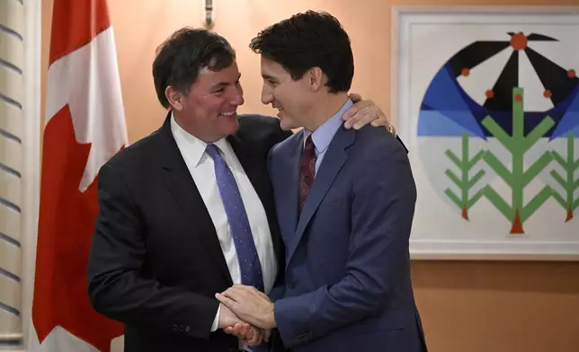 Prime Minister Justin Trudeau, right, congratulates Dominic LeBlanc, left, after LeBlanc was sworn in as finance minister at a ceremony at Rideau Hall in Ottawa, Ontario, Monday, Dec. 16, 2024. (Justin Tang/The Canadian Press via AP)