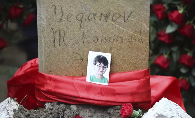 The tomb of Mahammadali Eganov, 13 who died in the Azerbaijan Airlines Embraer 190 crash near the Kazakhstan's Aktau airport, in Baku, Azerbaijan, Saturday, Dec. 28, 2024. (AP Photo)