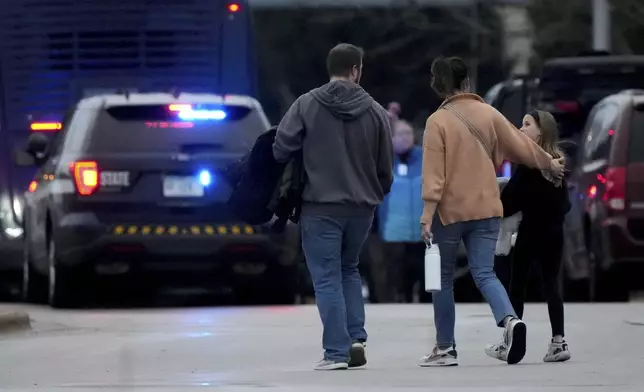 Families leave the SSMI Health Center, set up as a reunification center, following a shooting, Monday, Dec. 16, 2024 in Madison, Wis. (AP Photo/Morry Gash)