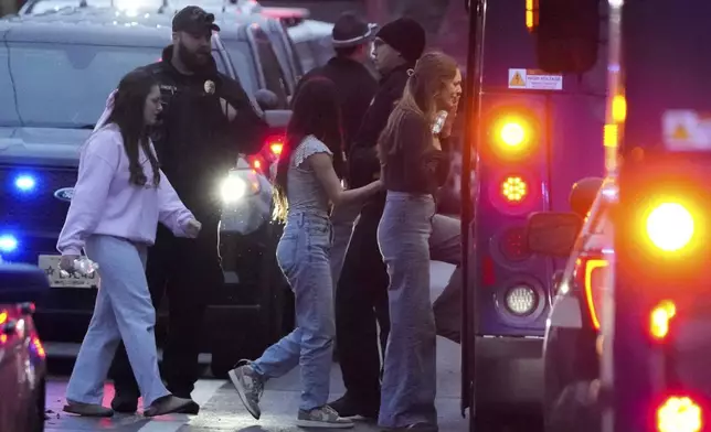 Students aboard a bus as they leave the shelter following a shooting at the Abundant Life Christian School, Monday, Dec. 16, 2024. (AP Photo/Morry Gash)