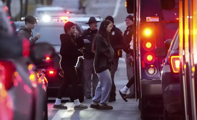 Students aboard a bus as they leave the shelter following a shooting at the Abundant Life Christian School, Monday, Dec. 16, 2024. (AP Photo/Morry Gash)