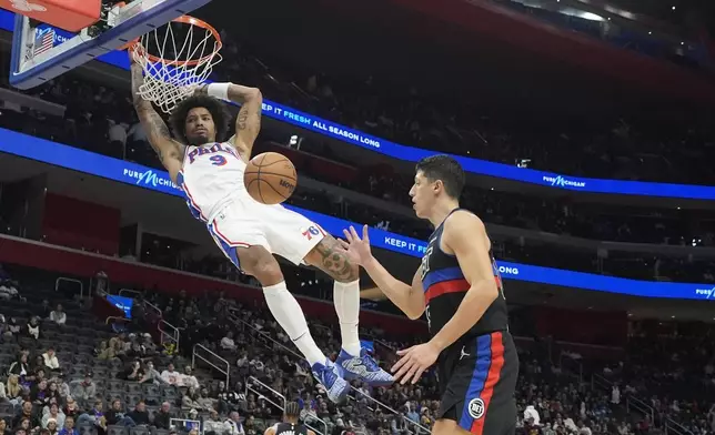 Philadelphia 76ers guard Kelly Oubre Jr. (9) dunks next to Detroit Pistons forward Simone Fontecchio during the second half of an NBA basketball game, Saturday, Nov. 30, 2024, in Detroit. (AP Photo/Carlos Osorio)