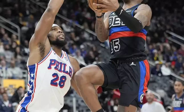 Detroit Pistons guard Marcus Sasser (25) makes a layup as Philadelphia 76ers forward Guerschon Yabusele (28) defends during the first half of an NBA basketball game, Saturday, Nov. 30, 2024, in Detroit. (AP Photo/Carlos Osorio)