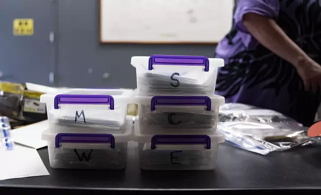 Containers of lists and photographs from each location of "Two by Twos" conventions organized by Pam Waltons are pictured at a library, Monday, Dec. 9, 2024, in Wailea, Hawaii. (AP Photo/Mengshin Lin)