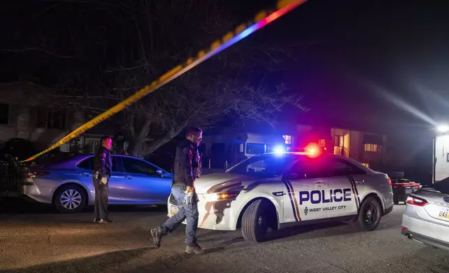 Police investigate a crime scene where they say multiple family members were found dead inside a home in West Valley City, Utah, Tuesday Dec. 17, 2024. (Scott G. Winterton/The Deseret News via AP)