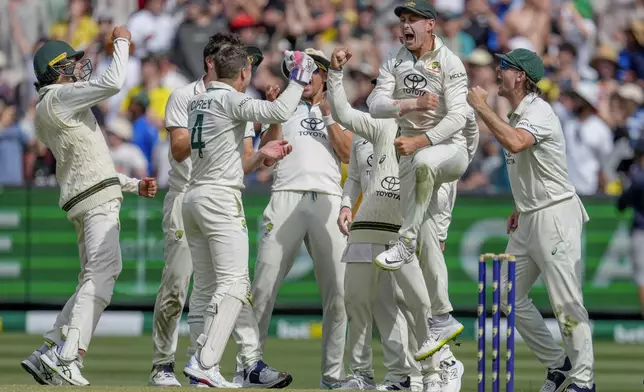 Australian players celebrates the wicket of India's Yashasvi Jaiswal during play on the last day of the fourth cricket test between Australia and India at the Melbourne Cricket Ground, Melbourne, Australia, Monday, Dec. 30, 2024. (AP Photo/Asanka Brendon Ratnayake)