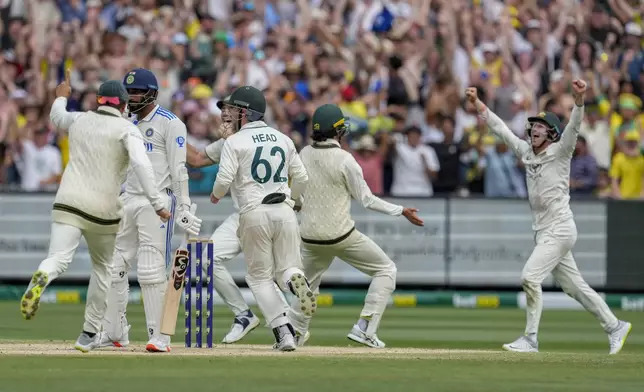 Australian players celebrates the wicket of India's Jasprit Bumrah during play on the last day of the fourth cricket test between Australia and India at the Melbourne Cricket Ground, Melbourne, Australia, Monday, Dec. 30, 2024. (AP Photo/Asanka Brendon Ratnayake)