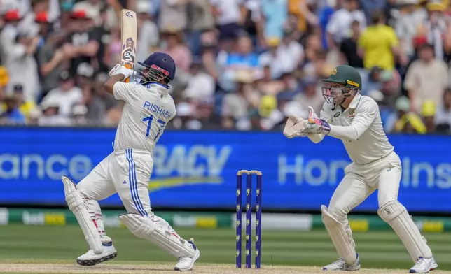 India's Rishabh Pant plays a shot in the air before being caught out by Australia's Mitchell Marsh during play on the last day of the fourth cricket test between Australia and India at the Melbourne Cricket Ground, Melbourne, Australia, Monday, Dec. 30, 2024. (AP Photo/Asanka Brendon Ratnayake)