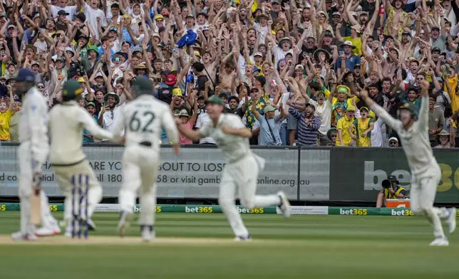 Spectators react to dismissal of India's Jasprit Bumrah during play on the last day of the fourth cricket test between Australia and India at the Melbourne Cricket Ground, Melbourne, Australia, Monday, Dec. 30, 2024. (AP Photo/Asanka Brendon Ratnayake)