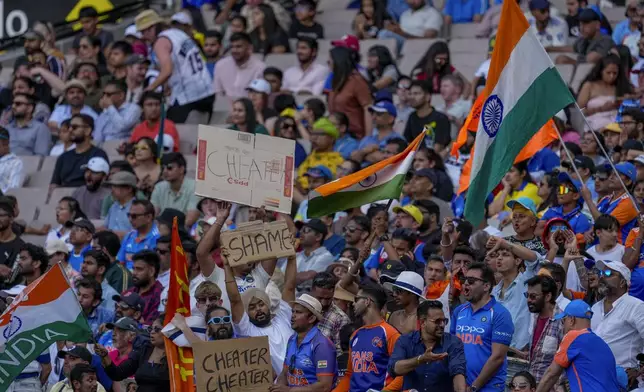 Indian fans hold placards following controversial DRS decision of India's Yashasvi Jaiswal during play on the last day of the fourth cricket test between Australia and India at the Melbourne Cricket Ground, Melbourne, Australia, Monday, Dec. 30, 2024. (AP Photo/Asanka Brendon Ratnayake)