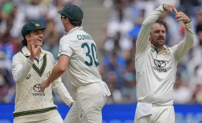 Australia's captain Pat Cummins, center, Travis Head, left, and Sam Konstas celebrates the wicket of India's Rishabh Pant during play on the last day of the fourth cricket test between Australia and India at the Melbourne Cricket Ground, Melbourne, Australia, Monday, Dec. 30, 2024. (AP Photo/Asanka Brendon Ratnayake)