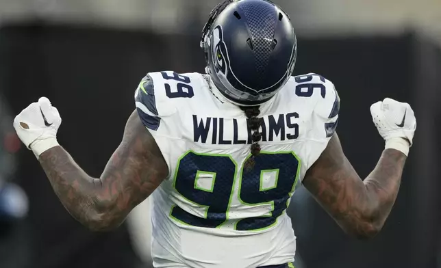 Seattle Seahawks defensive end Leonard Williams (99) reacts after sacking New York Jets quarterback Aaron Rodgers during the fourth quarter of an NFL football game, Sunday, Dec. 1, 2024, in East Rutherford, N.J. (AP Photo/Seth Wenig)