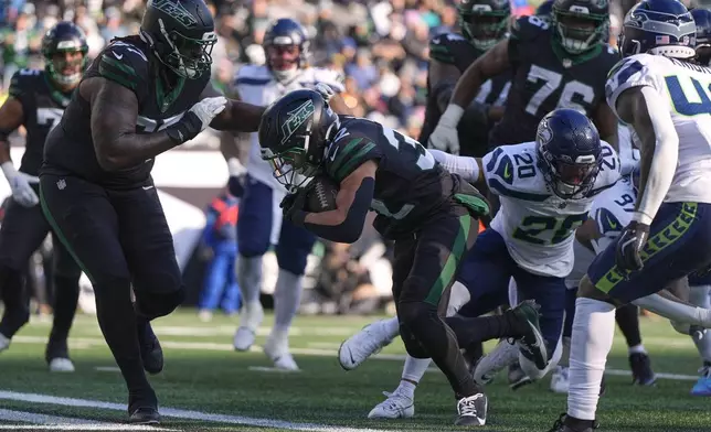 New York Jets running back Isaiah Davis (32) carries the ball across the goal line for a touchdown against the Seattle Seahawks during the first quarter of an NFL football game, Sunday, Dec. 1, 2024, in East Rutherford, N.J. (AP Photo/Julia Demaree Nikhinson)