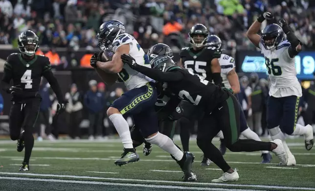 Seattle Seahawks running back Zach Charbonnet (26) crosses the goal line to score a touchdown against the New York Jets during the fourth quarter of an NFL football game, Sunday, Dec. 1, 2024, in East Rutherford, N.J. (AP Photo/Seth Wenig)