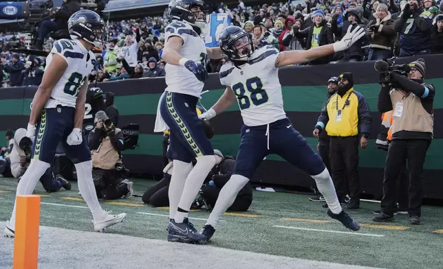 Seattle Seahawks tight end AJ Barner (88) reacts after scoring a touchdown against the New York Jets during the second quarter of an NFL football game, Sunday, Dec. 1, 2024, in East Rutherford, N.J. (AP Photo/Julia Demaree Nikhinson)