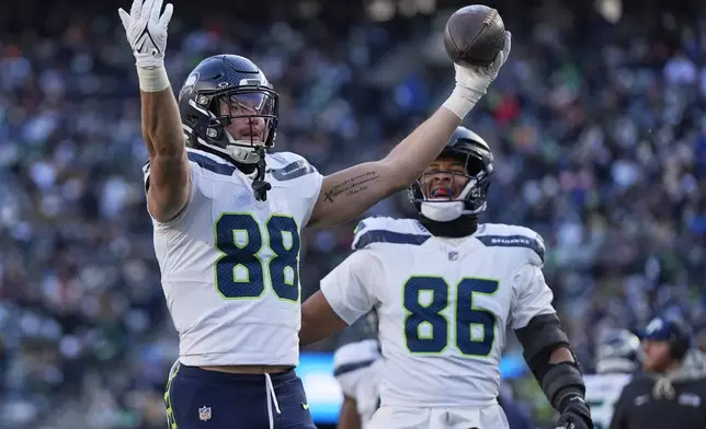 Seattle Seahawks tight end AJ Barner (88) reacts after scoring a touchdown against the New York Jets during the second quarter of an NFL football game, Sunday, Dec. 1, 2024, in East Rutherford, N.J. (AP Photo/Julia Demaree Nikhinson)