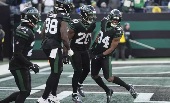 New York Jets running back Kene Nwangwu (34) reacts after running back a kickoff 99 yards for a touchdown against the Seattle Seahawks during the second quarter of an NFL football game, Sunday, Dec. 1, 2024, in East Rutherford, N.J. (AP Photo/Seth Wenig)