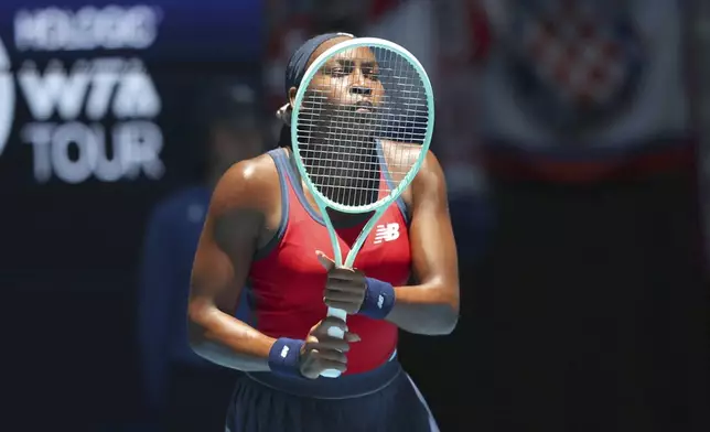 Coco Gauff of the United States looks through her racquet as she awaits a serve from Donna Vekic of Croatia during their United Cup tennis match in Perth, Australia, Tuesday, Dec. 31, 2024. (AP Photo/Trevor Collens)