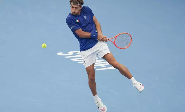 Italy's Flavio Cobolli plays a backhand return to France's Ugo Humbert during their match at the United Cup tennis tournament in Sydney, Australia, Tuesday, Dec. 31, 2024. (AP Photo/Mark Baker)