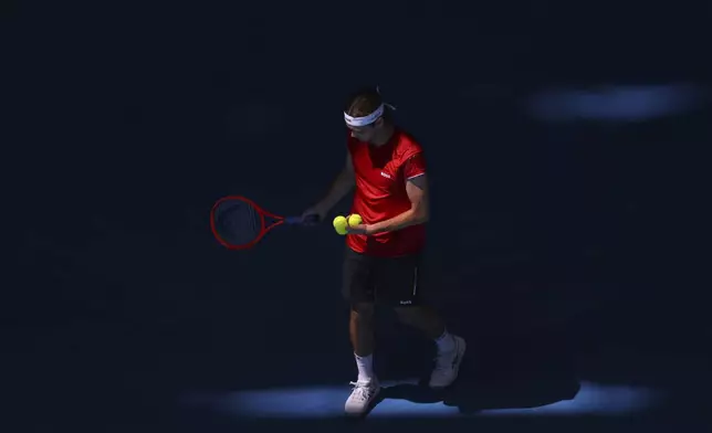 Taylor Fritz of the United States moves through shadows on the court as he prepares to serve to Borna Coric of Croatia during their United Cup tennis match in Perth, Australia, Tuesday, Dec. 31, 2024. (AP Photo/Trevor Collens)