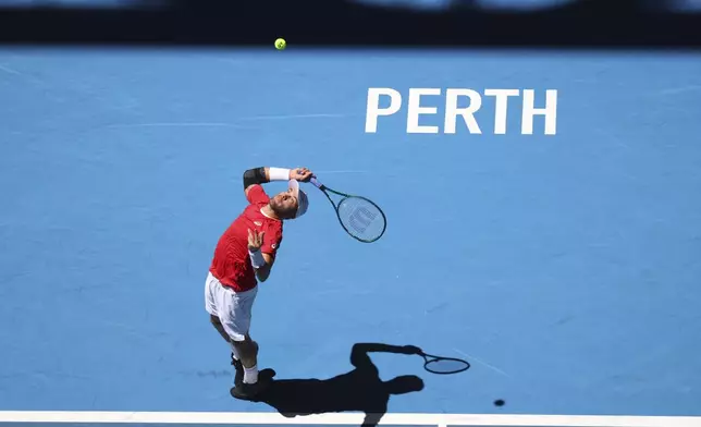 Borna Coric of Croatia serves to Taylor Fritz of the United States during their United Cup tennis match in Perth, Australia, Tuesday, Dec. 31, 2024. (AP Photo/Trevor Collens)