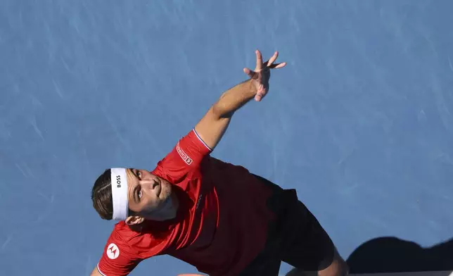 Taylor Fritz of the United States serves to Borna Coric of Croatia during their United Cup tennis match in Perth, Australia, Tuesday, Dec. 31, 2024. (AP Photo/Trevor Collens)