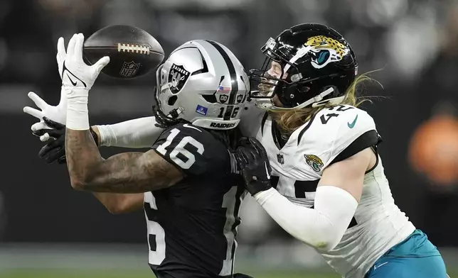 Jacksonville Jaguars safety Andrew Wingard (42) breaks up a pass intended for Las Vegas Raiders wide receiver Jakobi Meyers (16) during the second half of an NFL football game Sunday, Dec. 22, 2024, in Las Vegas. (AP Photo/John Locher)