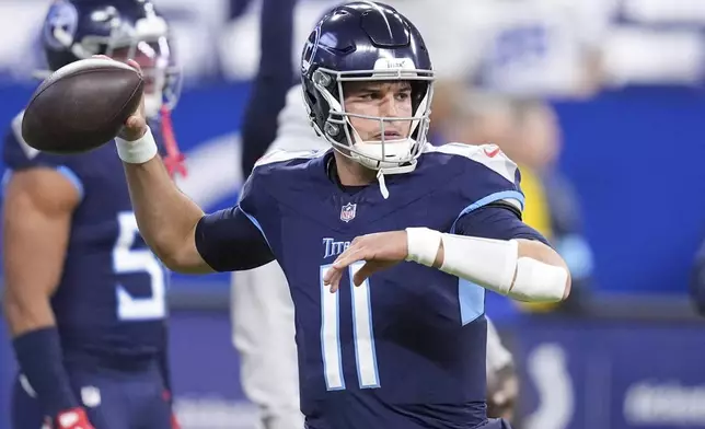 Tennessee Titans quarterback Mason Rudolph (11) warms up before an NFL football game against the Indianapolis Colts, Sunday, Dec. 22, 2024, in Indianapolis. (AP Photo/Michael Conroy)