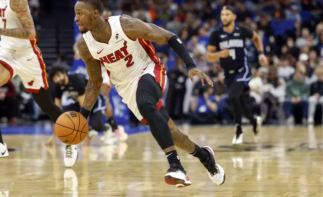 Miami Heat guard Terry Rozier (2) brings the ball down court against the Orlando Magic during the first half of an NBA basketball game, Thursday, Dec. 26, 2024, in Orlando, Fla. (AP Photo/Kevin Kolczynski)