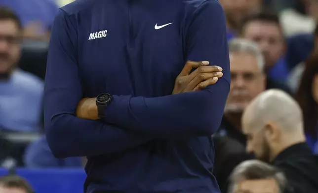 Orlando Magic head coach Jamahl Mosley reacts to his team playing the Miami Heat during the first half of an NBA basketball game, Thursday, Dec. 26, 2024, in Orlando, Fla. (AP Photo/Kevin Kolczynski)