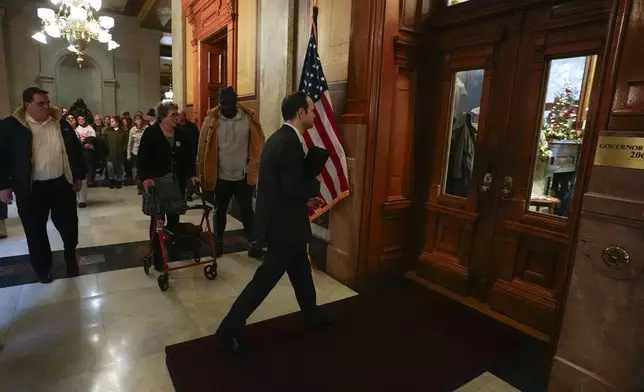 David Frank walks into the governor's office during a gathering of the Indiana Abolition Coalition at the Statehouse, Thursday, Dec. 12, 2024, in Indianapolis. (AP Photo/Darron Cummings)