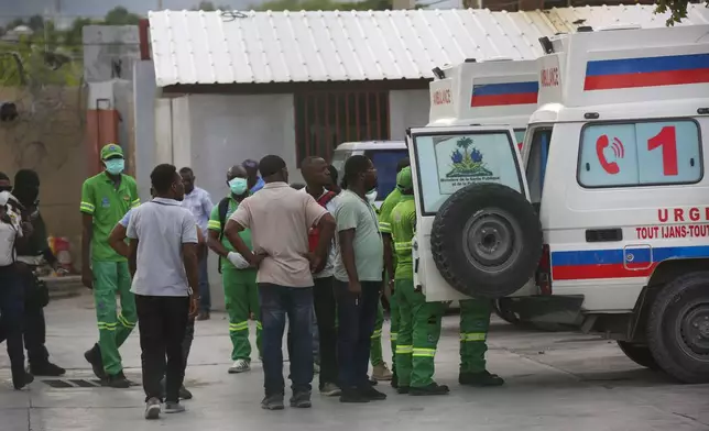 Medics inspect an ambulance of wounded people, shot by armed gangs at the General Hospital, in Port-au-Prince, Haiti, Tuesday, Dec. 24, 2024. (AP Photo/Odelyn Joseph)