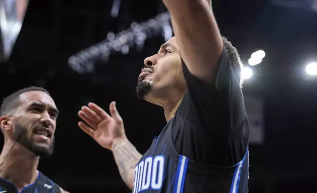 Orlando Magic guard Cole Anthony, right, celebrates a shot against the Miami Heat with teammate guard Trevelin Queen during the second half of an NBA basketball game, Saturday, Dec. 21, 2024, in Orlando, Fla. (AP Photo/John Raoux)