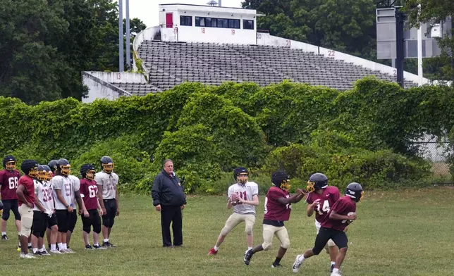 Boston Latin football coach Rocco Zizza, center, watches his team practice on the field outisde White Stadium, Thursday, Sept. 26, 2024, at Franklin Park in Boston. A plan to renovate the aging stadium in Boston for a professional women's soccer team has sparked controversy over concerns it will displace some youth sports and limit access to a public park in one of the city's most diverse neighborhoods. (AP Photo/Charles Krupa)