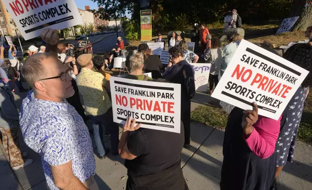 People display placards during a rally held to save White Stadium, Wednesday, Sept. 11, 2024, in Boston. (AP Photo/Steven Senne)