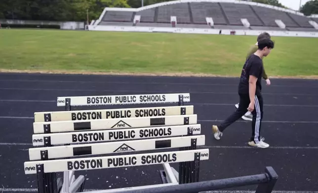 Students from a Boston Latin School physical education class cool down after running on the track at White Stadium, Thursday, Sept. 26, 2024, at Franklin Park in Boston. A plan to renovate the aging stadium in Boston for a professional women's soccer team has sparked controversy over concerns it will displace some youth sports and limit access to a public park in one of the city's most diverse neighborhoods. (AP Photo/Charles Krupa)