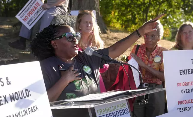 Renee Stacey Welch, front left, addresses a crowd during a rally held to save White Stadium, Wednesday, Sept. 11, 2024, in Boston. (AP Photo/Steven Senne)