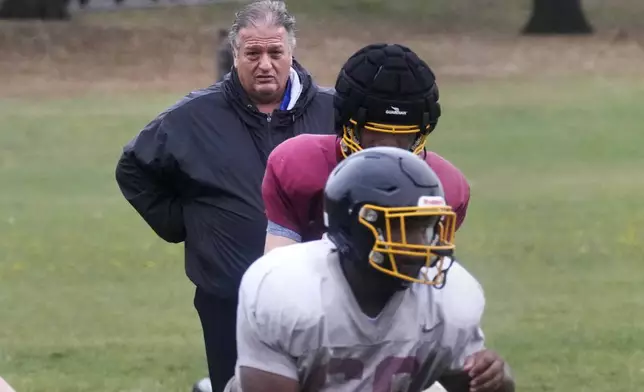 Boston Latin football coach Rocco Zizza, center, watches his team practice on the field outisde White Stadium, Thursday, Sept. 26, 2024, at Franklin Park in Boston. A plan to renovate the aging stadium in Boston for a professional women's soccer team has sparked controversy over concerns it will displace some youth sports and limit access to a public park in one of the city's most diverse neighborhoods. (AP Photo/Charles Krupa)