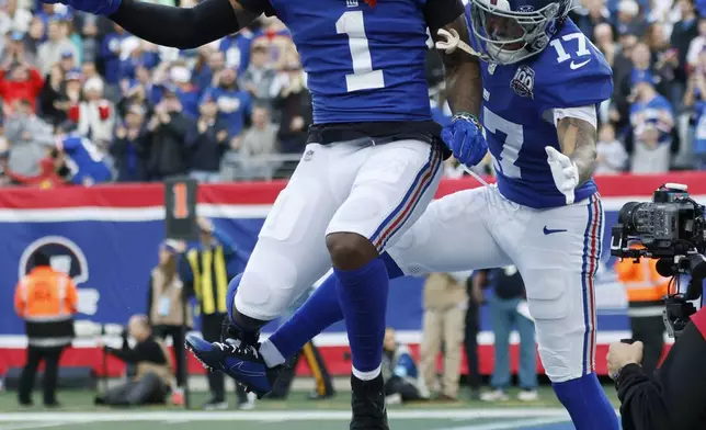 New York Giants wide receiver Wan'Dale Robinson (17) celebrates with Malik Nabers (1) after Robinson scored a touchdown against the Indianapolis Colts in the first half of an NFL football game Sunday, Dec. 29, 2024, in East Rutherford, N.J. (AP Photo/Corey Sipkin)