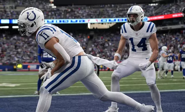 Indianapolis Colts wide receiver Michael Pittman Jr. (11) celebrates with Alec Pierce (14) after Pittman made a touchdown catch against the New York Giants in the second half of an NFL football game Sunday, Dec. 29, 2024, in East Rutherford, N.J. (AP Photo/Seth Wenig)