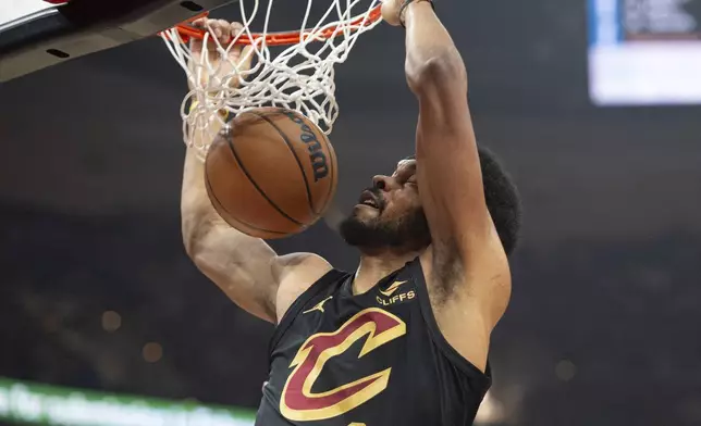 Cleveland Cavaliers' Jarrett Allen (31) dunks against the Philadelphia 76ers during the first half of an NBA basketball game in Cleveland, Saturday, Dec. 21, 2024. (AP Photo/Phil Long)