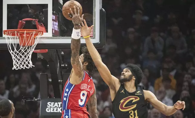 Philadelphia 76ers' Kelly Oubre Jr. (9) shoots over Cleveland Cavaliers' Jarrett Allen (31)during the first half of an NBA basketball game in Cleveland, Saturday Dec. 21, 2024. (AP Photo/Phil Long)