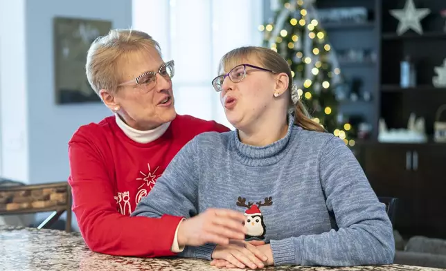 Kathleen Krueger and her daughter, Megan, 28, sit together at their home in Racine, Wis., Friday, Dec. 20, 2024. (AP Photo/Andy Manis)